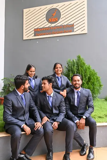 asian-indian-college-student-focus-working-laptop-reading-book-while-other-classmates-background-outdoor-picture-university-campus_466689-8079